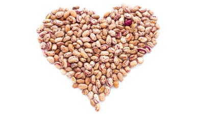 NutriSavvy_Pinto_Beans_Heart_DP_61451035_400x225 A heart made of beans on top of white background.